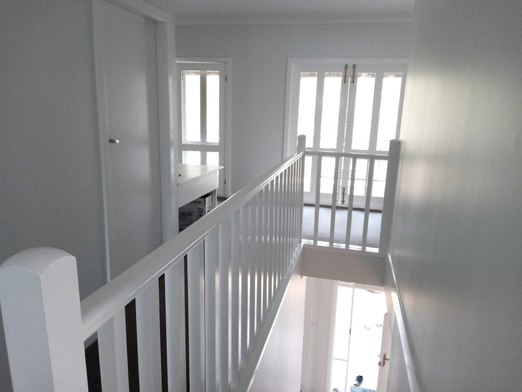 Upstairs of a house with a hand rail